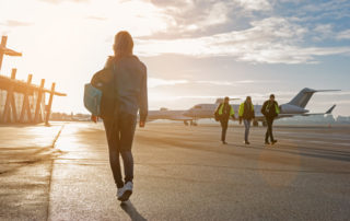 female-student-walking-school_bag-airport-tarmack